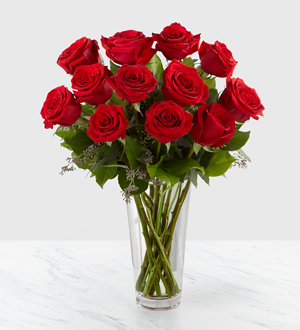 long stemmed red roses in a vase