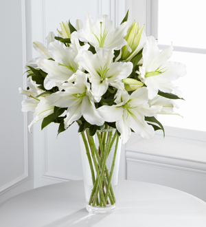 White lilies in a clear vase for funeral