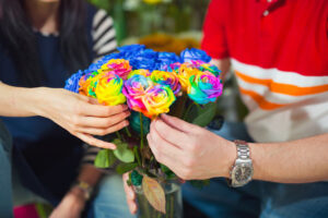 Close up man buys flowers in the flower shop, selective focus